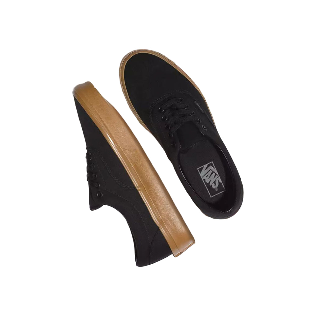 Black Vans shoes with tan soles on a white background