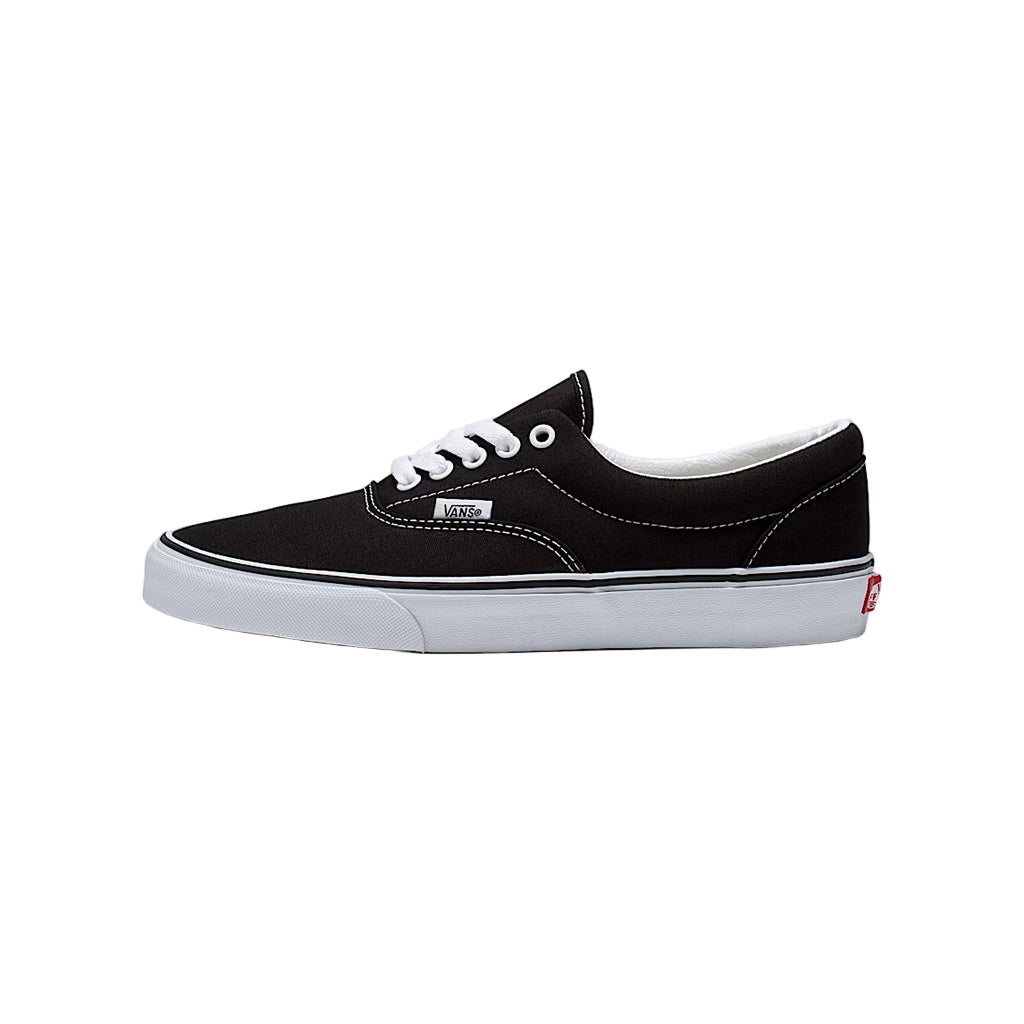 Black sneaker with white sole on a light gray background