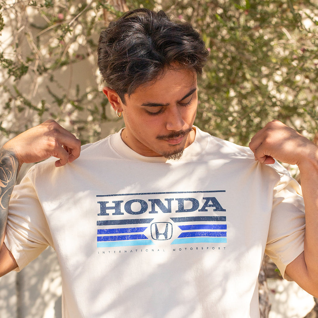 Man wearing a white t-shirt with Honda logo and text.