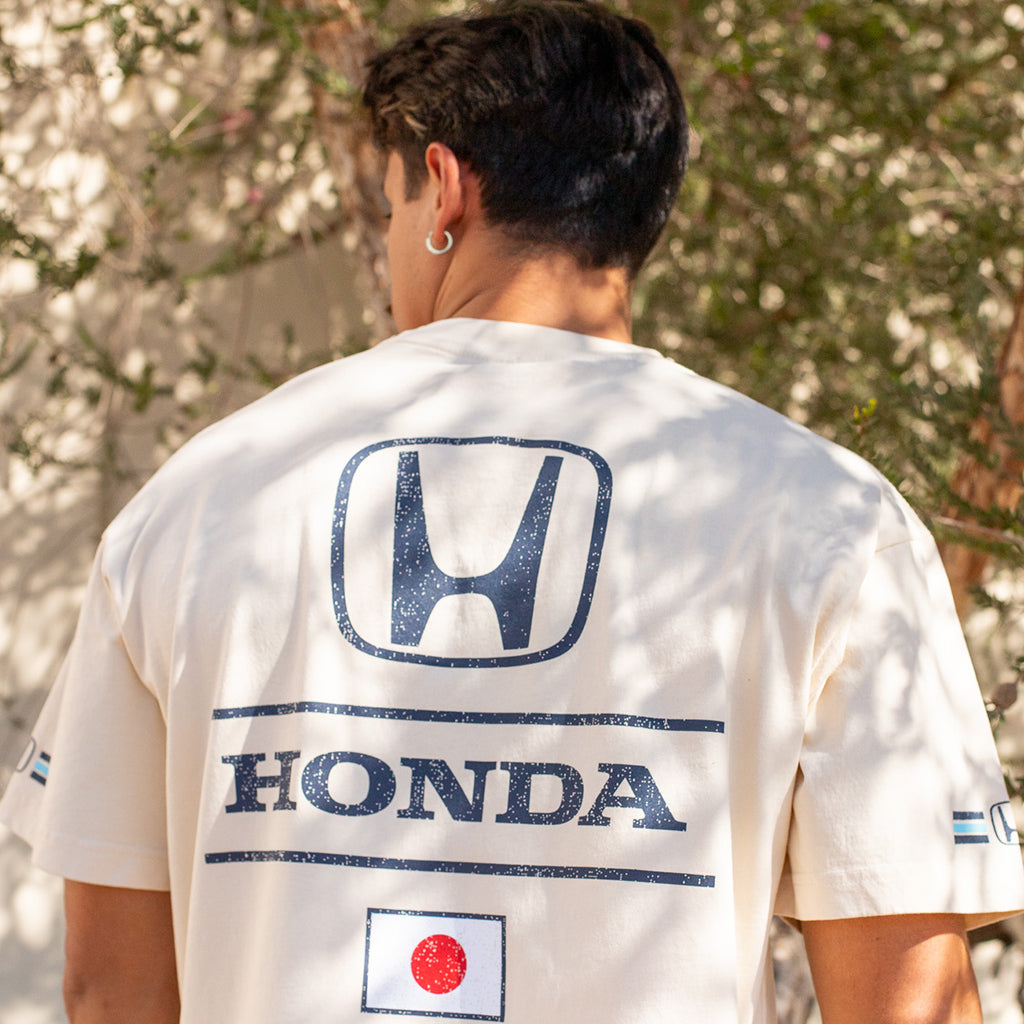 Person wearing a white t-shirt with Honda logo and Japanese flag