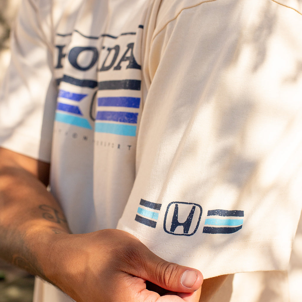 Close-up of a person wearing a white t-shirt with Honda logo and branding.