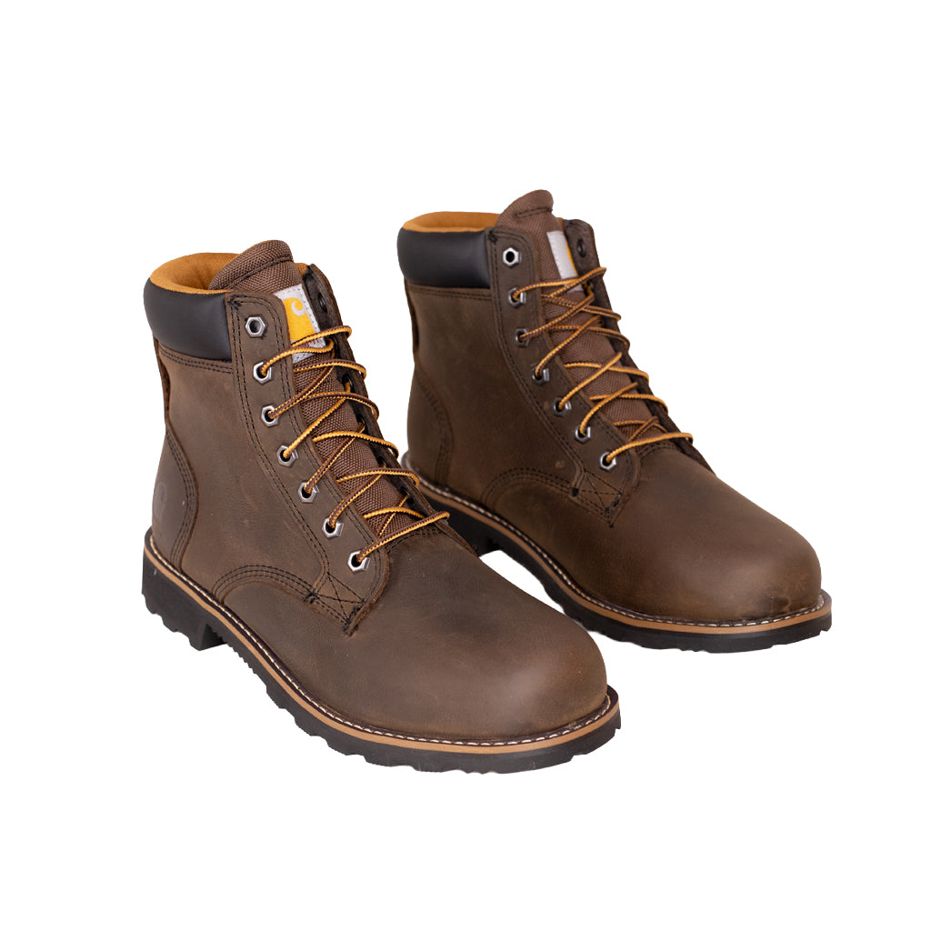 Pair of brown leather boots with orange laces on a white background