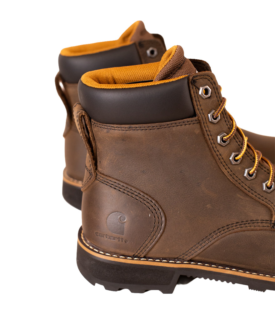 Brown work boots with yellow lining on a white background