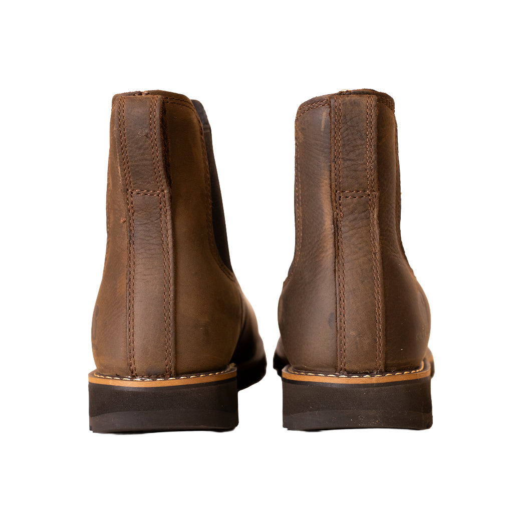 Pair of brown leather boots shown from the back on a white background