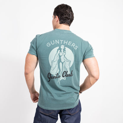 Man wearing a teal t-shirt with 'Gunthers Gentle Club' design on the back, on a white background