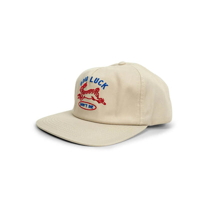 Beige cap with embroidered design on a white background