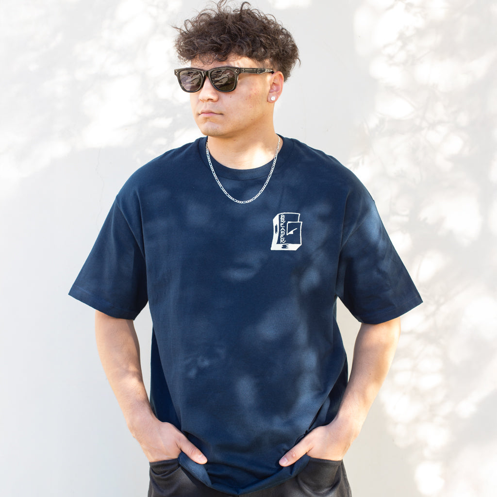 Person wearing a navy blue t-shirt with a logo on a white background