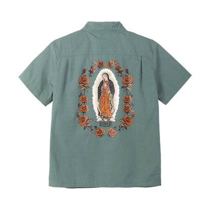 Green shirt with embroidered design of a religious figure and roses on the back