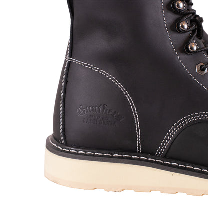 Close-up of a black boot with white stitching on a white background