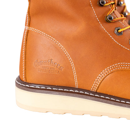 Close-up of a brown leather boot with stitching detail on a white background
