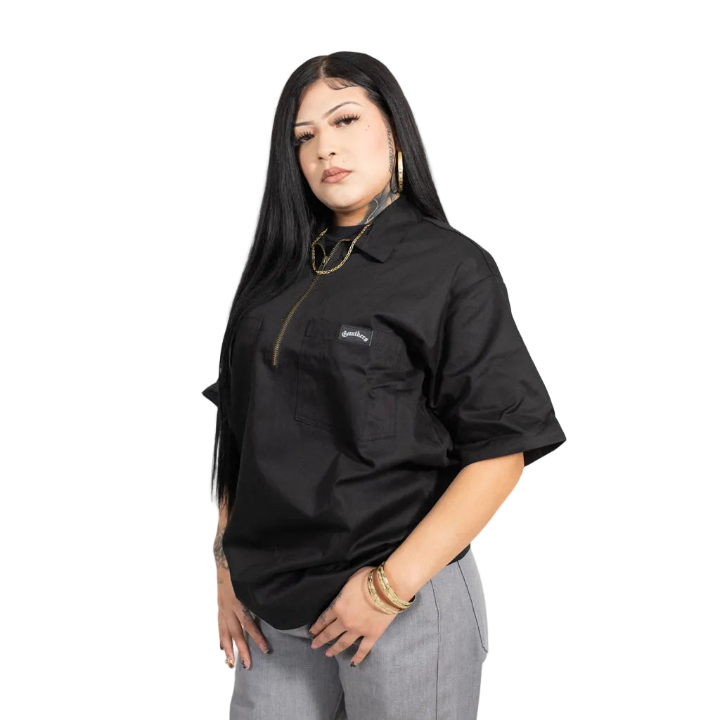 Woman wearing a black shirt with a brand logo on a white background