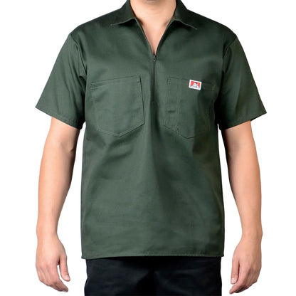 Green short-sleeve shirt with a logo on a gray background