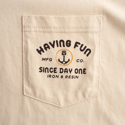 Beige shirt pocket with 'Having Fun' logo and text
