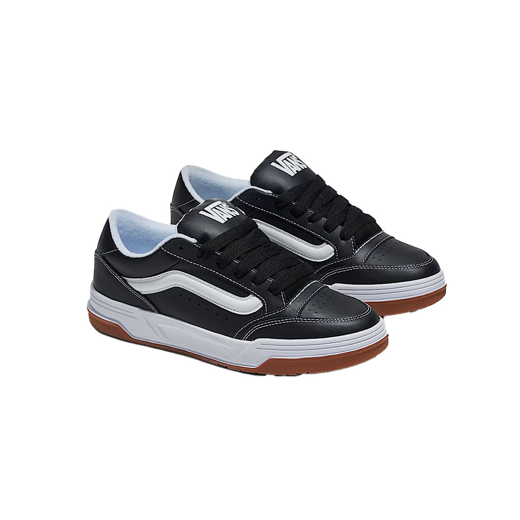 Black sneakers with white soles and brown soles on a white background
