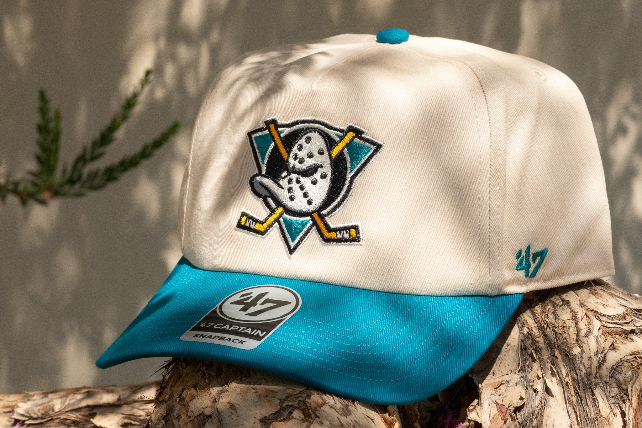 Beige and blue cap with a logo on a wooden surface