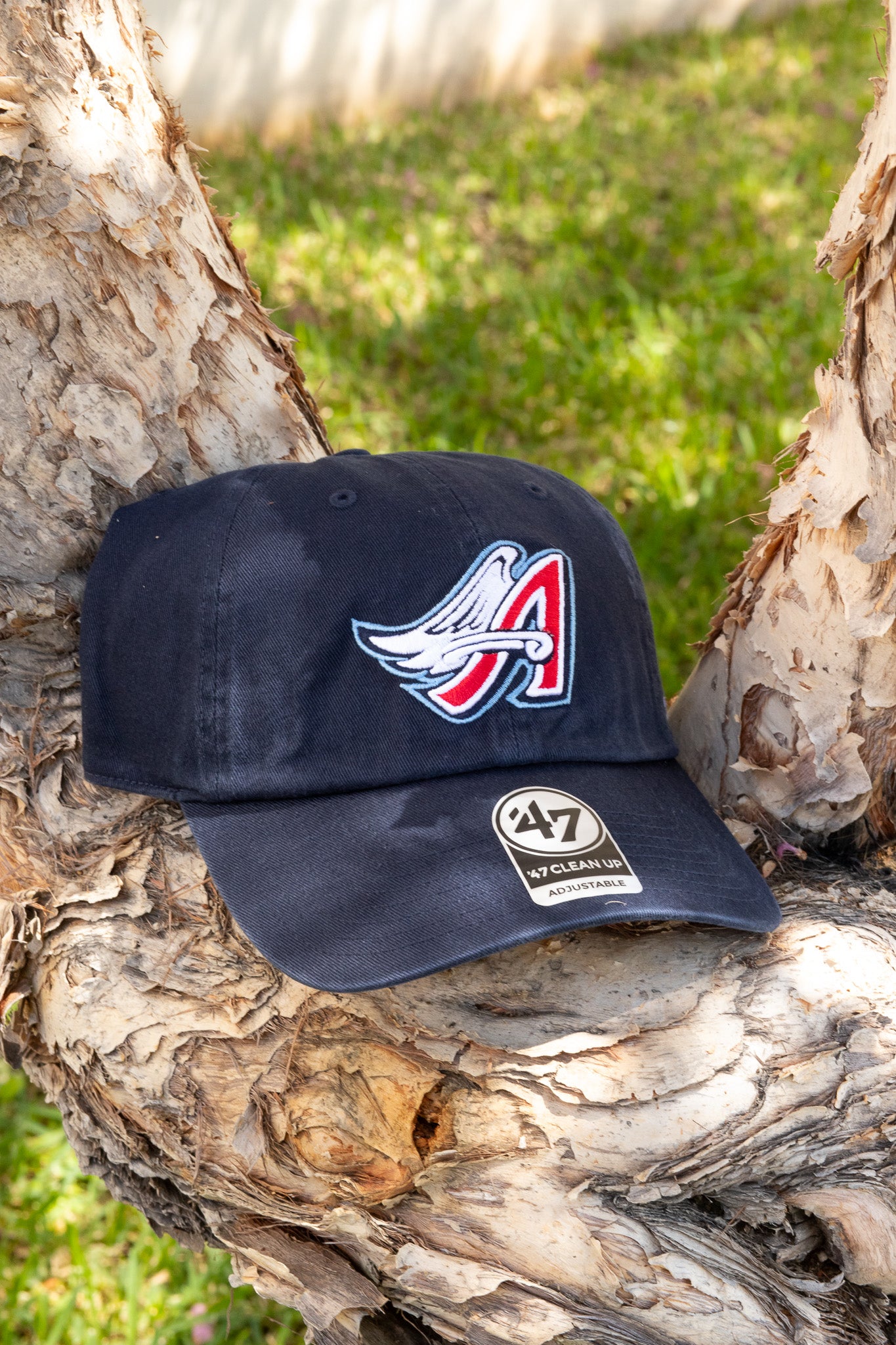 Navy blue cap with logo and '47' branding on a tree branch