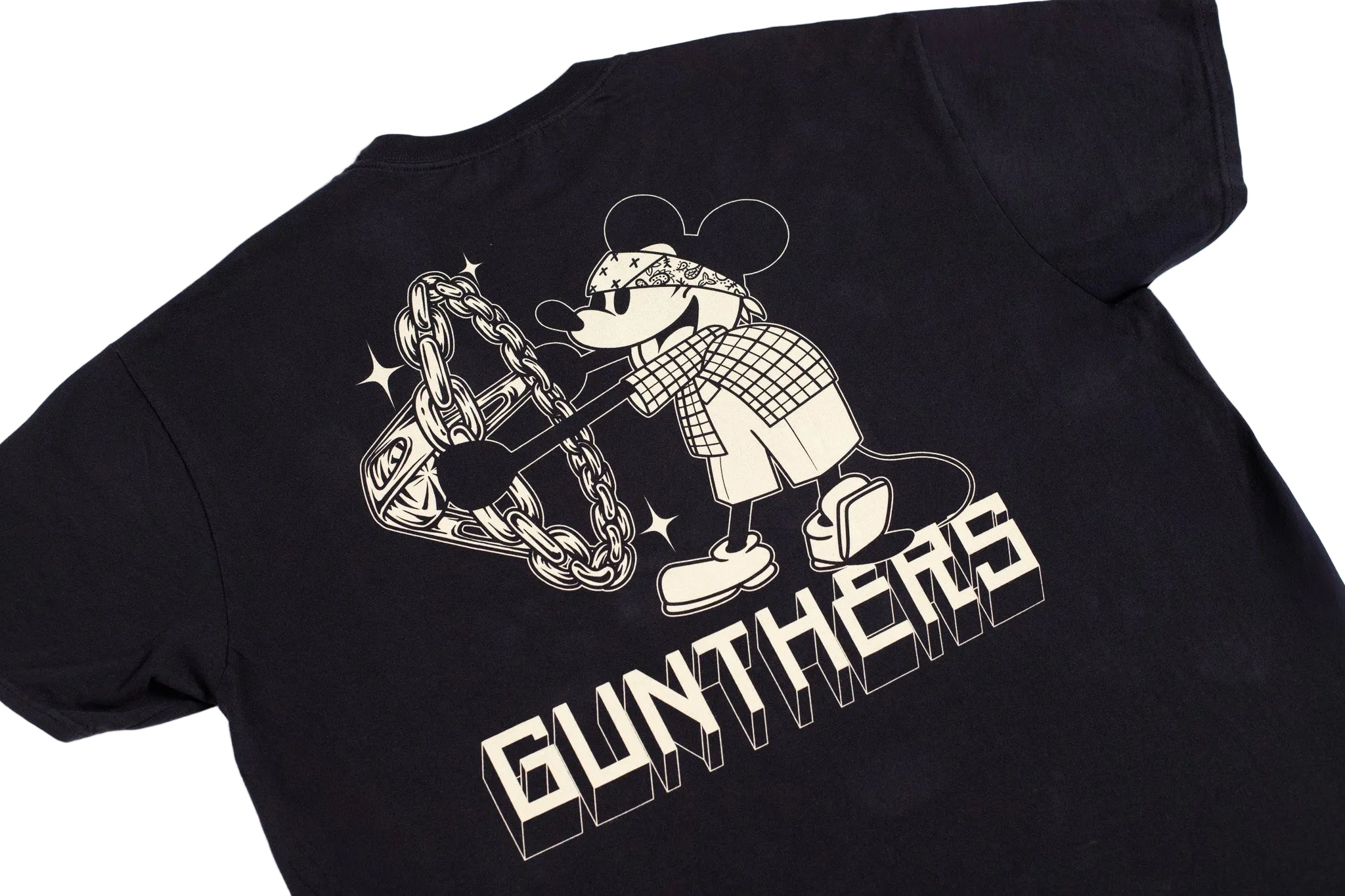 A black short-sleeve t-shirt laid flat on a white background, featuring a large graphic print of a cartoon mouse character wearing sunglasses and a plaid shirt, holding a chain, with the word 'GUNTHERS' in bold block letters below.