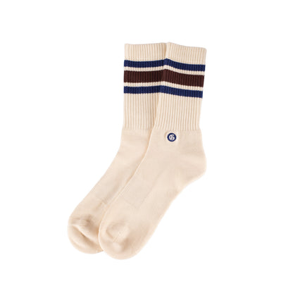 Beige socks with maroon and blue stripes on a white background