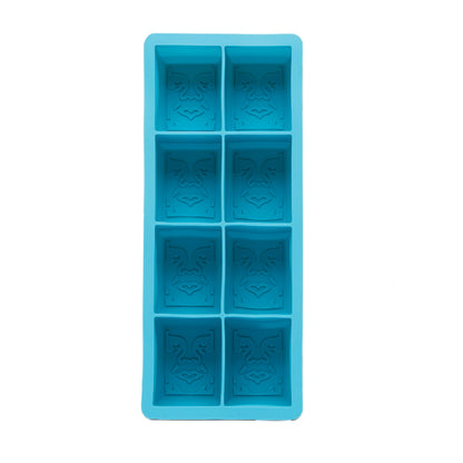 Blue silicone ice cube tray with obey icon on bottom on a white background