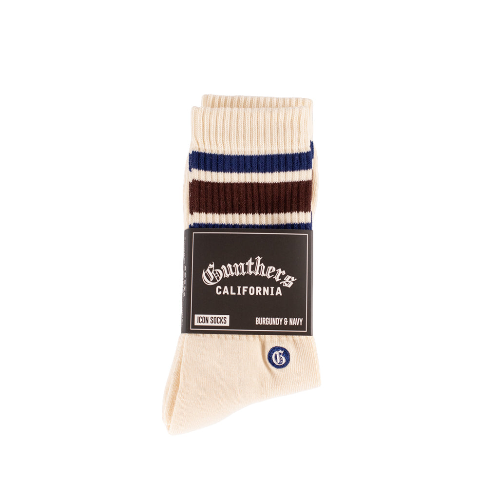 Beige sock with blue and maroon stripes on a white background, featuring Gunther's packaging.