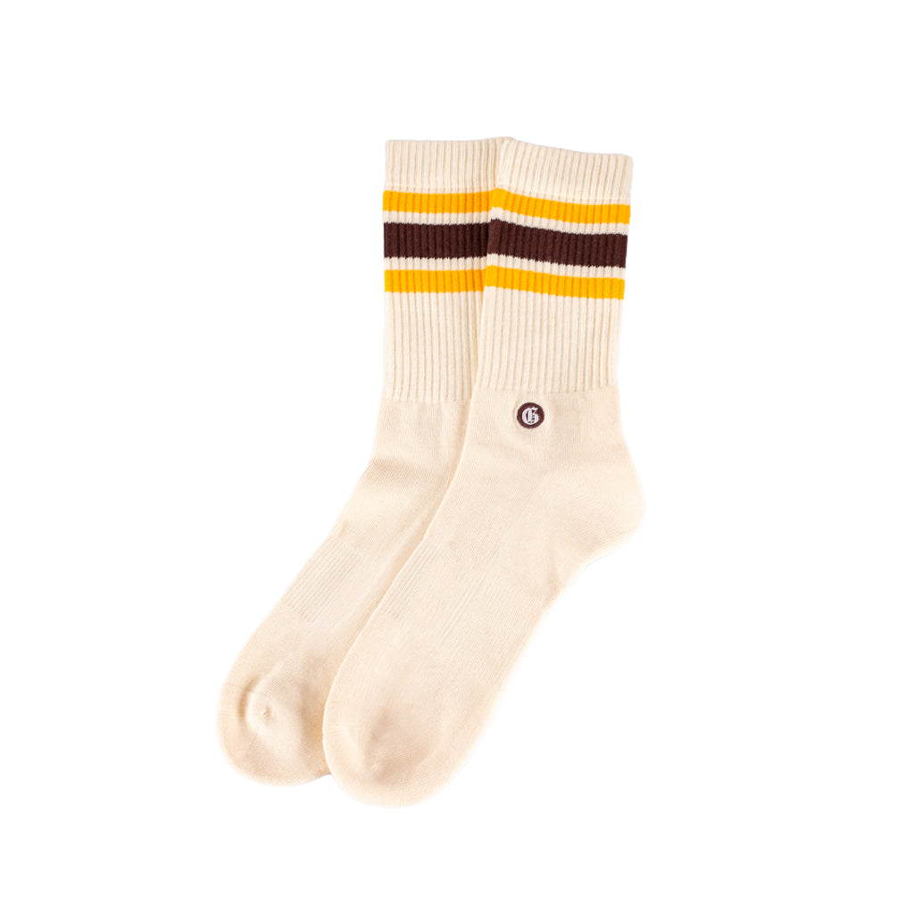 Cream-colored socks with yellow and maroon stripes on a white background