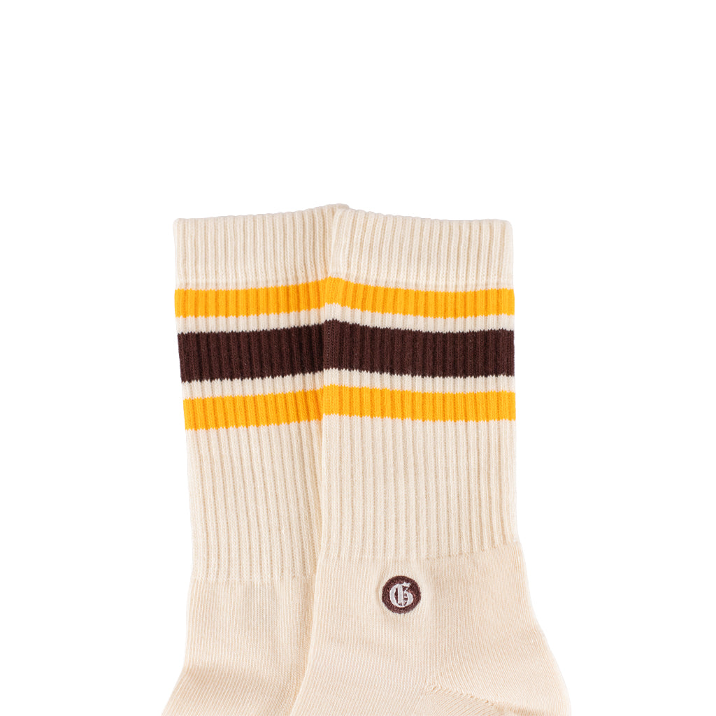Beige sock with yellow and maroon stripes on a white background