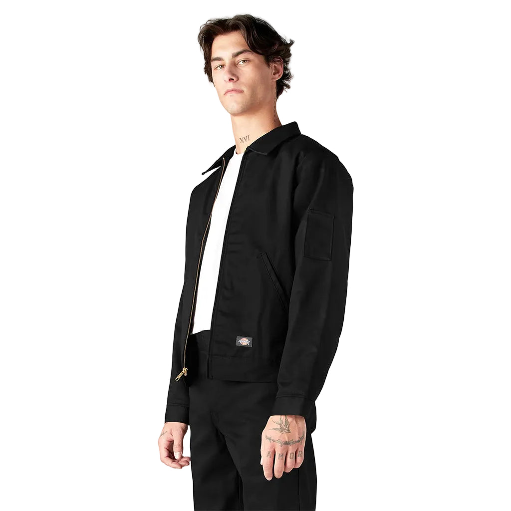 Person wearing a black jacket and pants on a white background