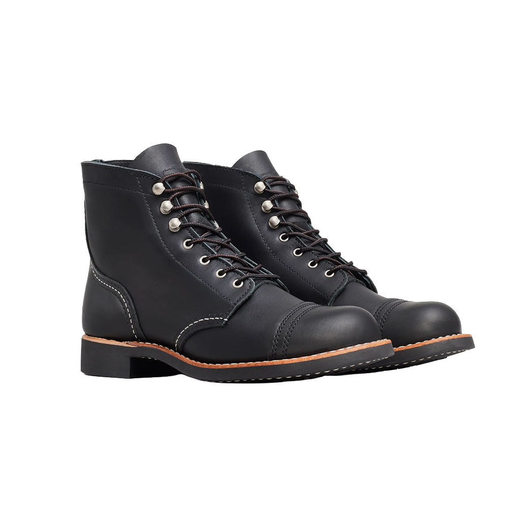 Pair of black leather boots on a white background