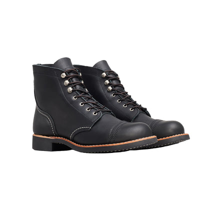 Pair of black leather boots on a white background