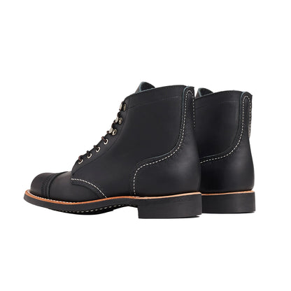 Pair of black leather boots on a white background