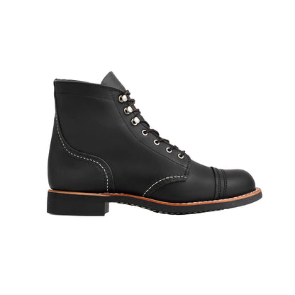 Black leather boot with brown sole on a white background