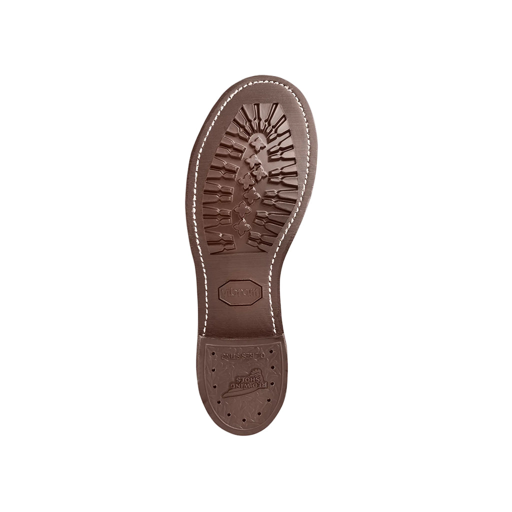 Brown leather shoe sole with stitching details on a white background