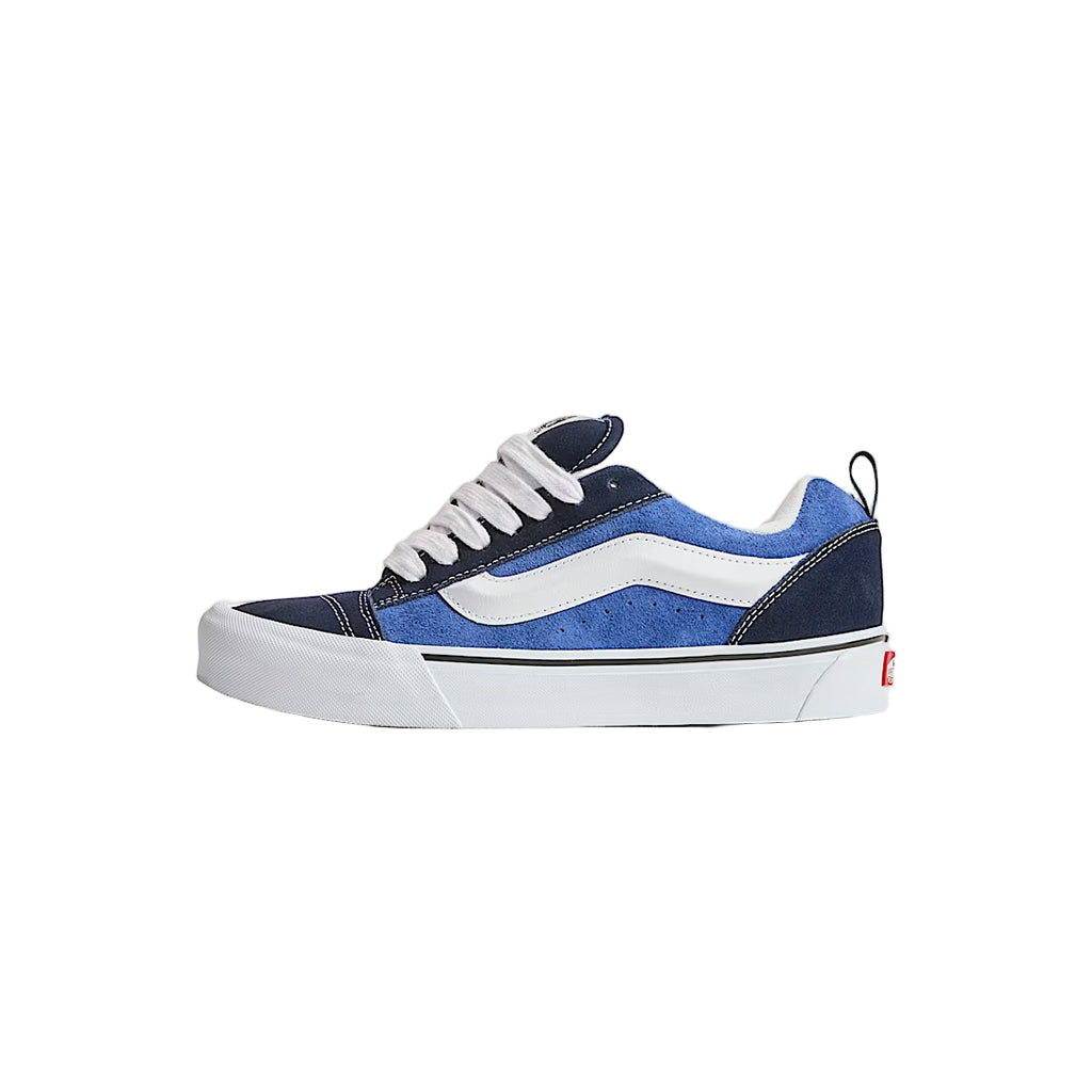 Blue and white sneaker on a light beige background