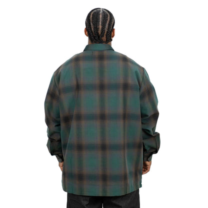 Person wearing a green plaid shirt on a white background