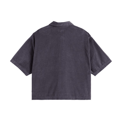 Back view of a dark gray textured shirt on a white background