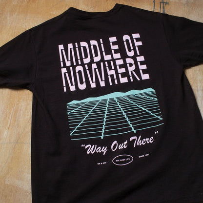 Black t-shirt with 'Middle of Nowhere' graphic design on a wooden surface