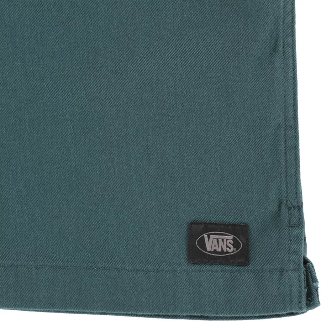 Close-up of a teal fabric with a Vans logo tag.