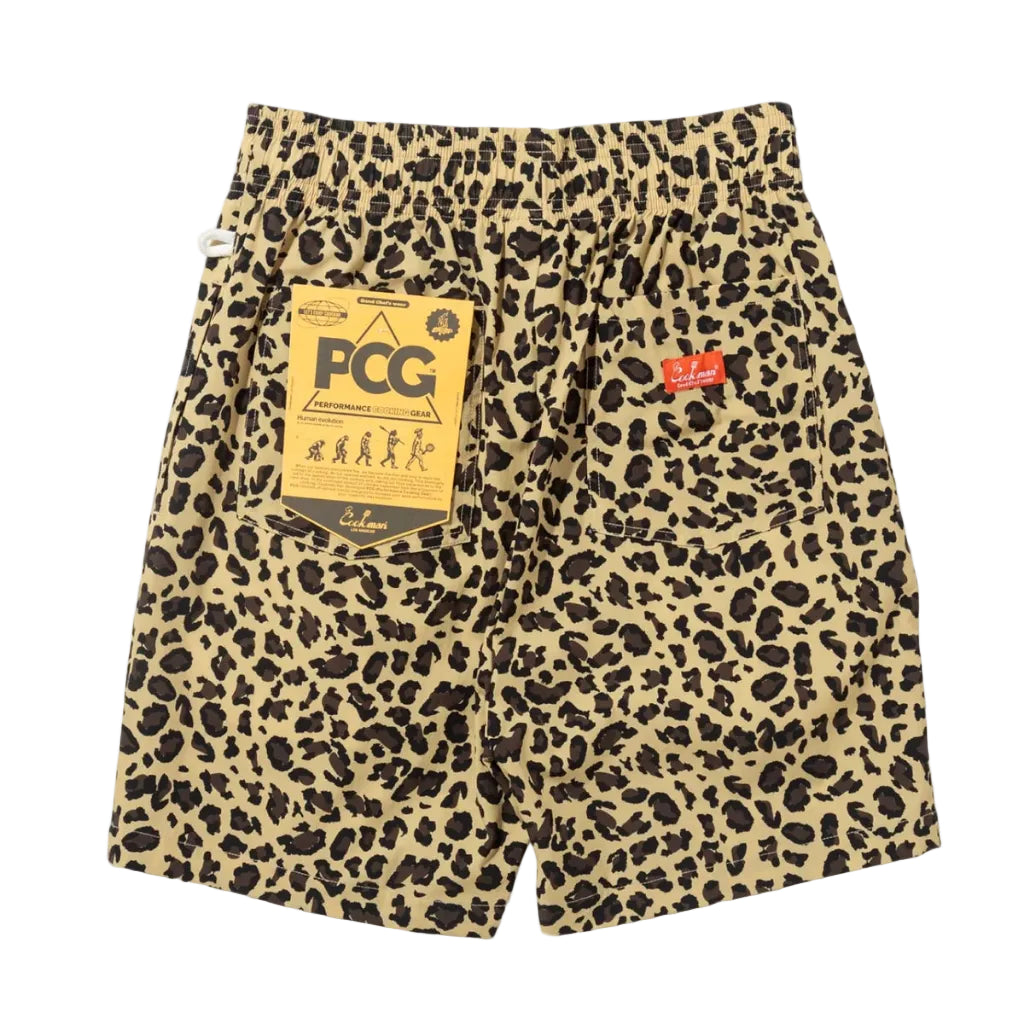 Leopard print shorts in beige and black, featuring a large gold PCG hangtag on the left pocket and a small red Cookman logo tab on the right pocket.