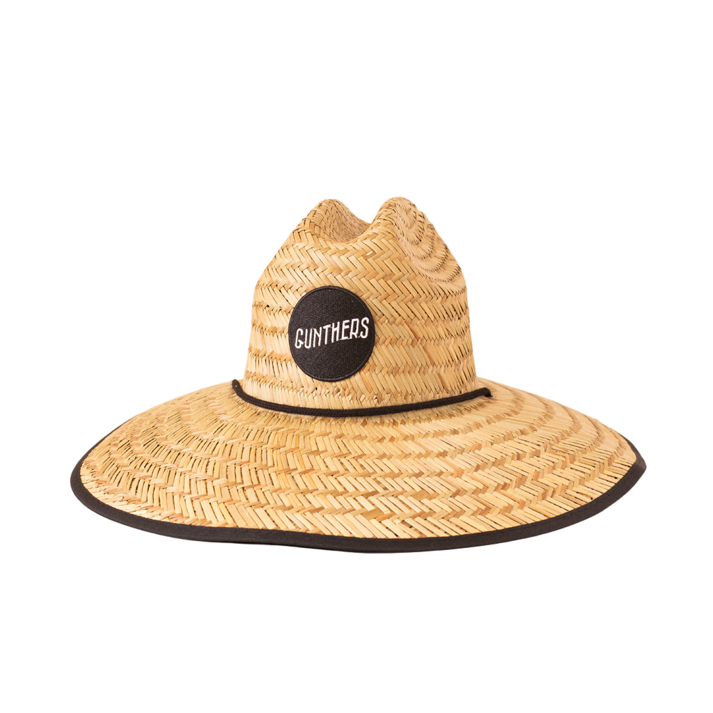 Woven straw hat with a black band and 'GUNTHERS' logo on a white background