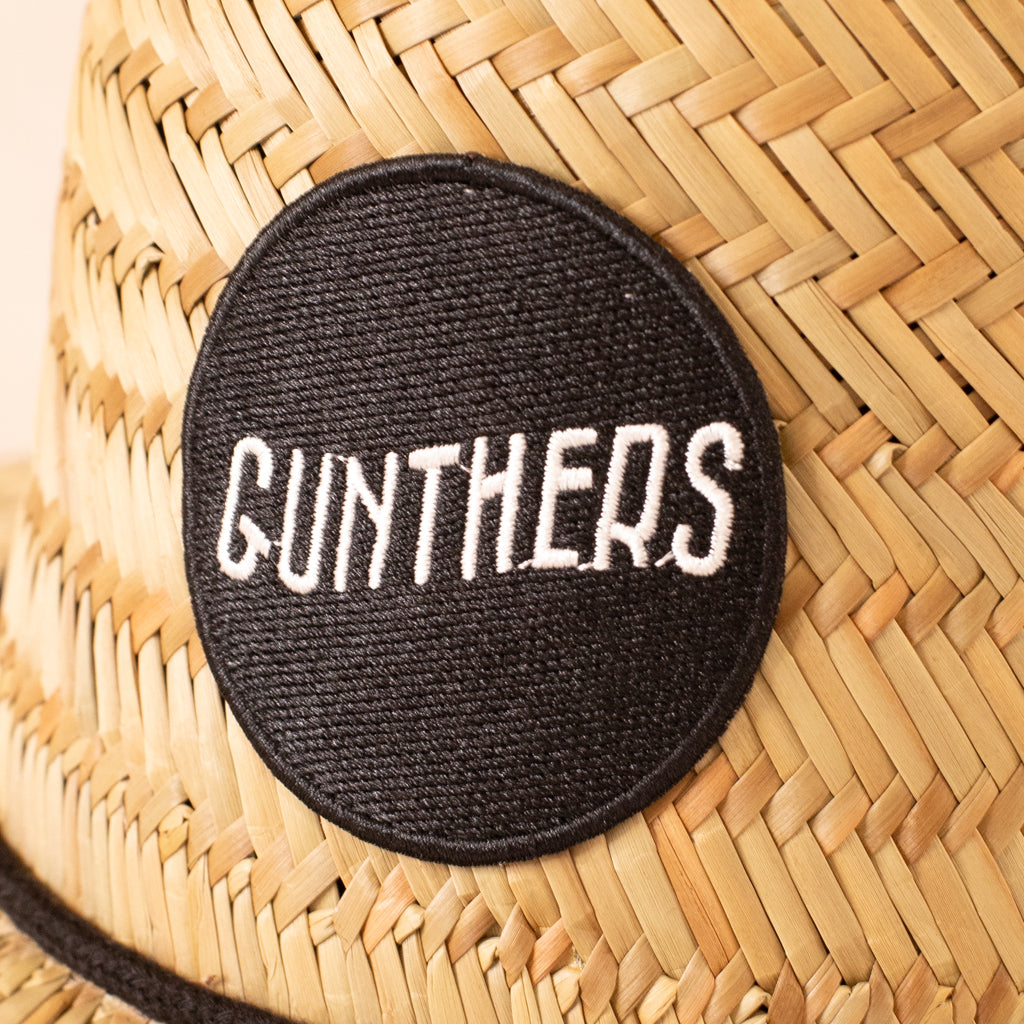 Black patch with 'GUNTHERS' text on a woven surface