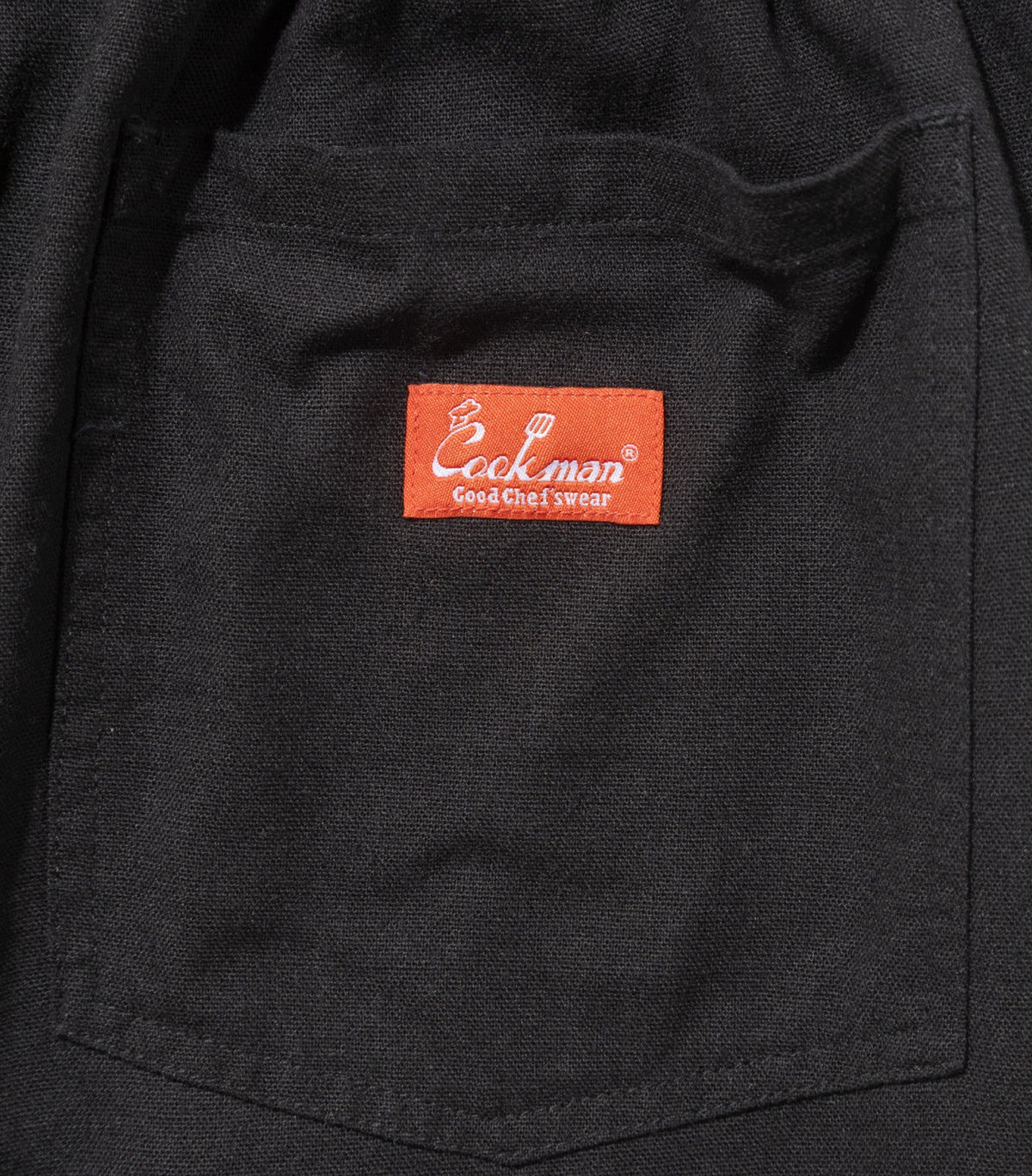 back pocket close up with a red logo on the center of the pocket