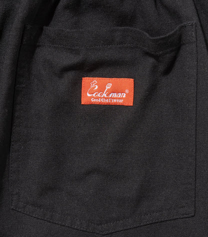 back pocket close up with a red logo on the center of the pocket