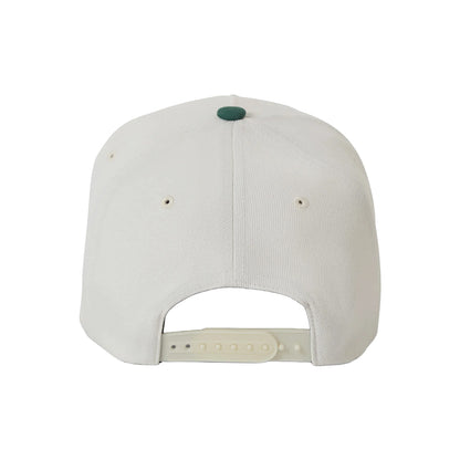 White cap with a green button on a white background