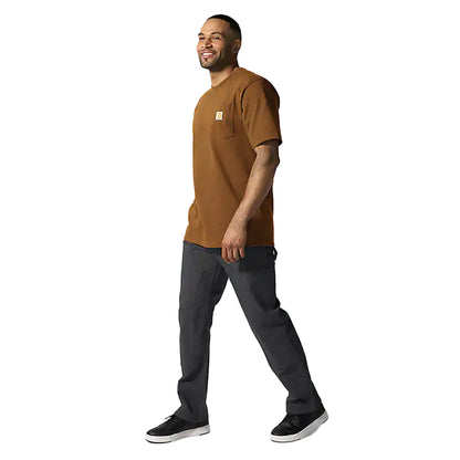 Man wearing a brown t-shirt and black pants on a white background