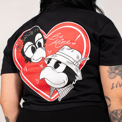 Black t-shirt with cartoon characters and 'Be Mine!' text on a red heart design.
