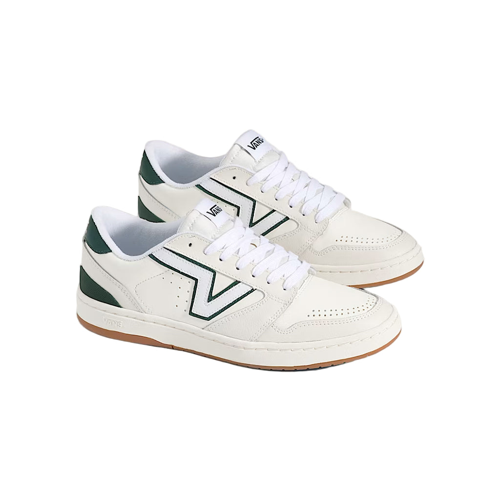 White sneakers with green accents on a light gray background