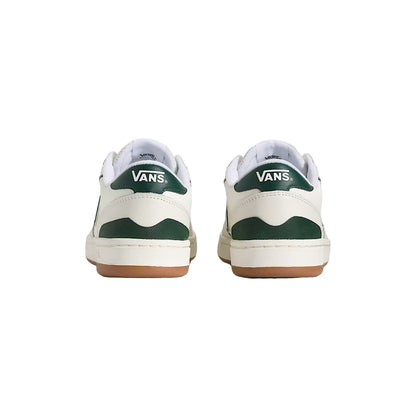 Pair of Vans sneakers with green and white design on a light background