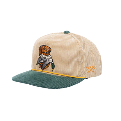 Beige cap with green brim and embroidered design on a white background