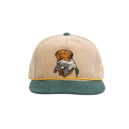 Beige and green cap with embroidered design on a white background