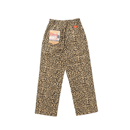 Leopard print pants with a brand tag on a white background